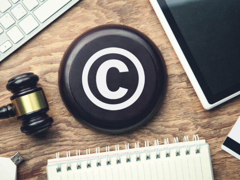 gavel on desk with notebook and a copyright symbol