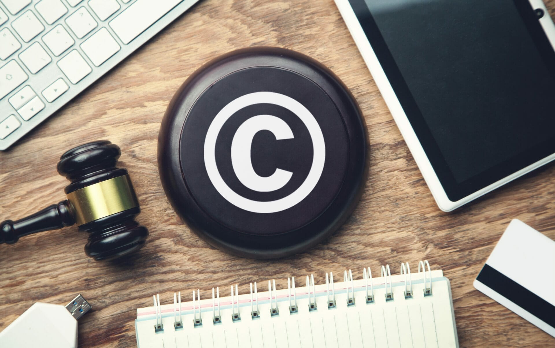 gavel on desk with notebook and a copyright symbol