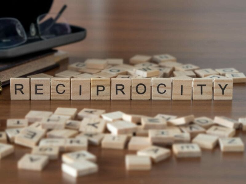 reciprocity spelled out in blocks on a desk