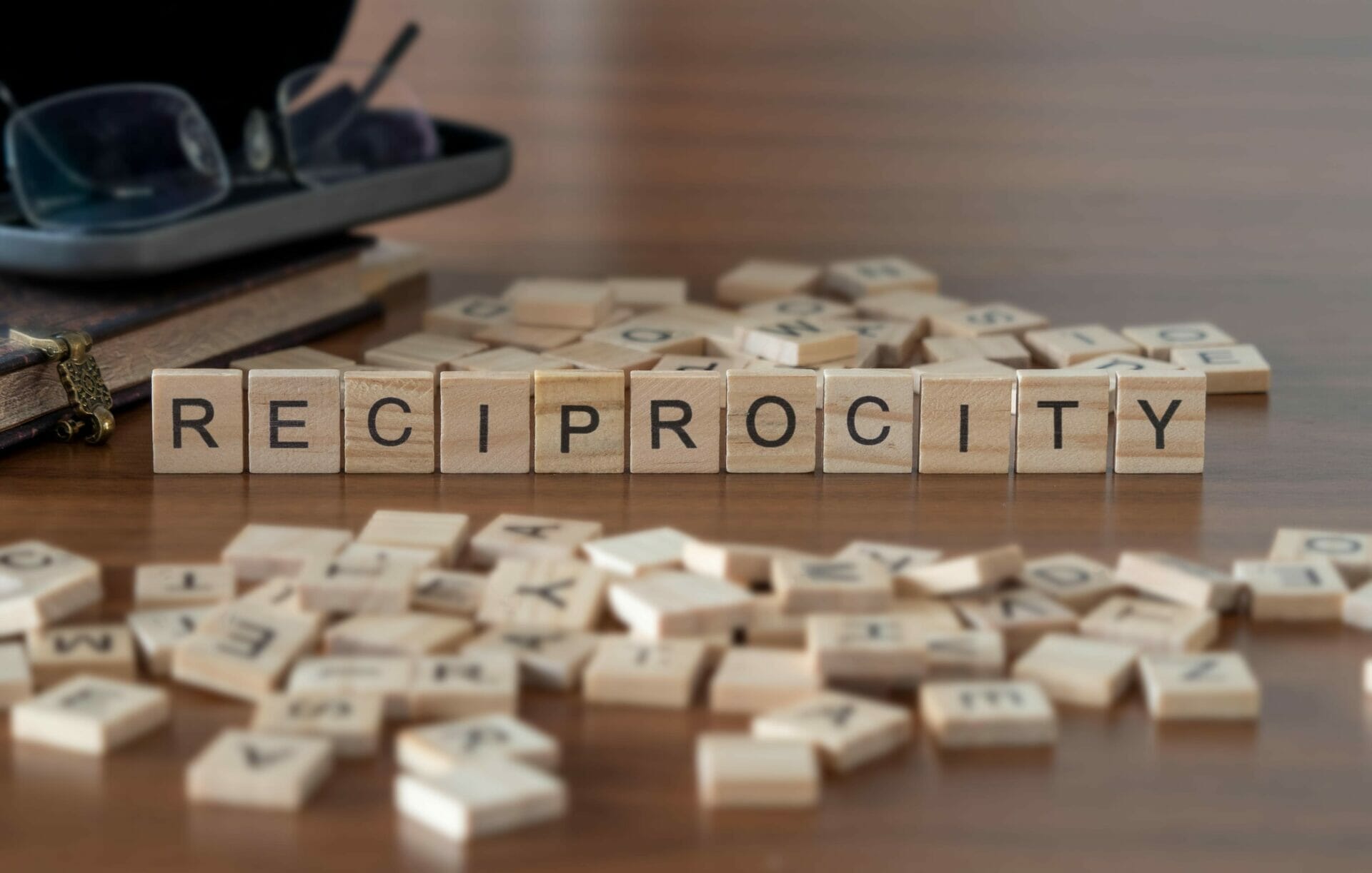 reciprocity spelled out in blocks on a desk