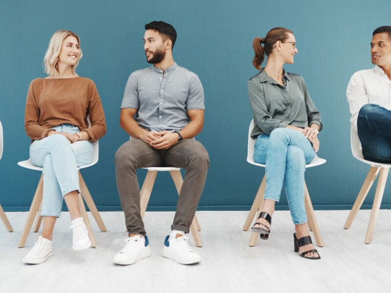 Employees in waiting room happy talking to each other