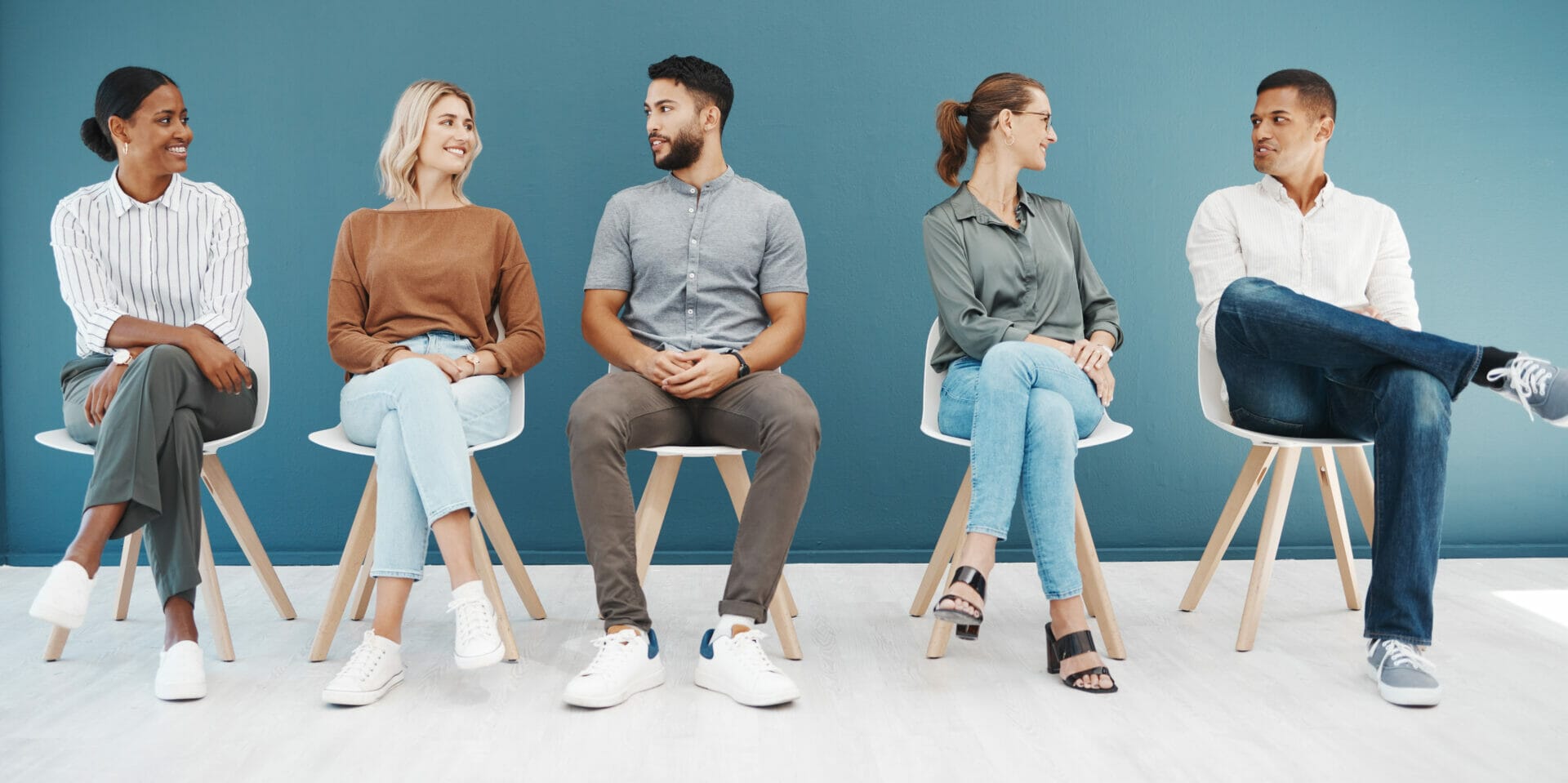 Employees in waiting room happy talking to each other