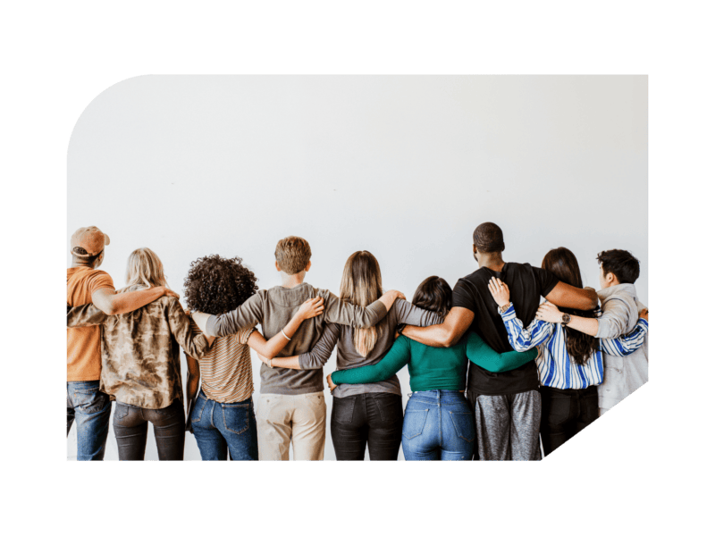 Group of diverse employees hugging facing wall