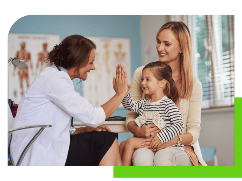 Mom and daughter at doctors office high five