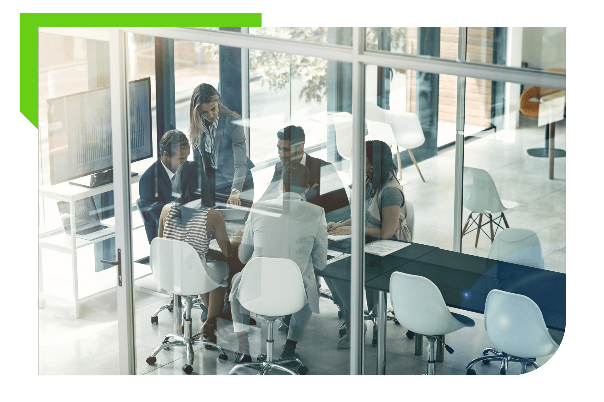 Group of professionals in meeting behind glass doors.