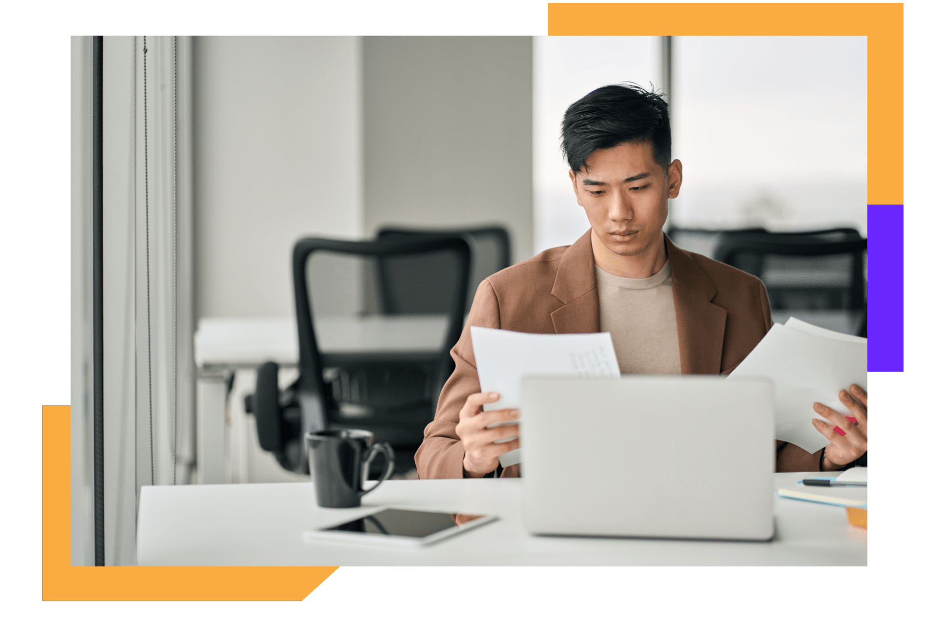 Man in beige suit analyzing paperwork