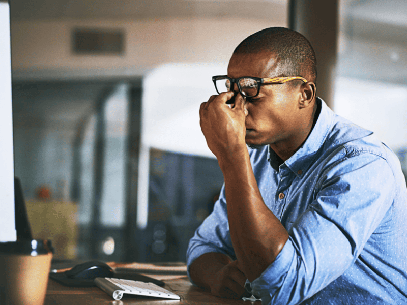 Business man sitting at desk stressed