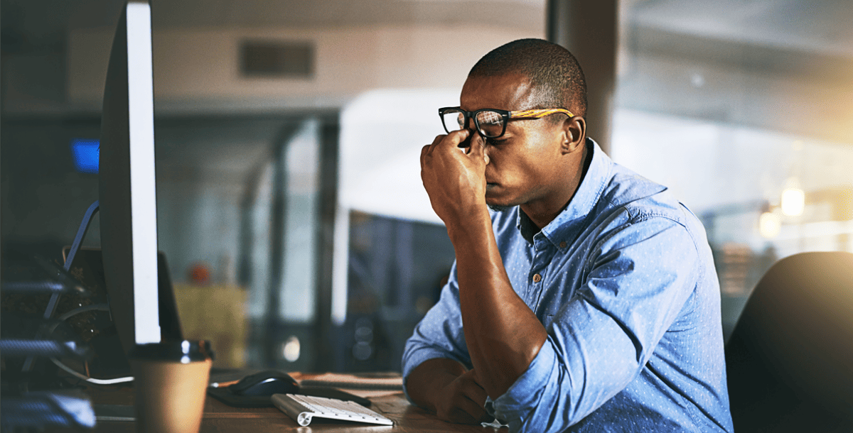 Business man sitting at desk stressed