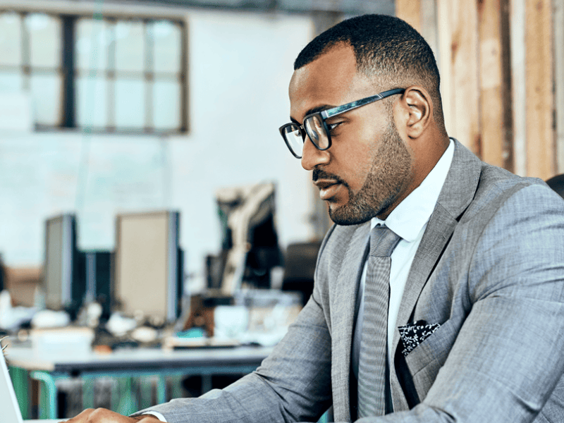 Man in suit looking at laptop