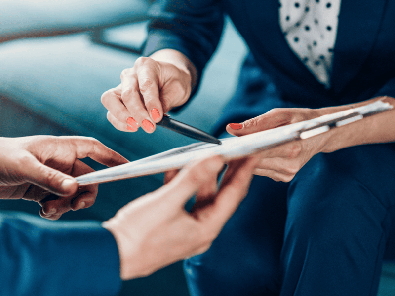 hands showing item on clipboard