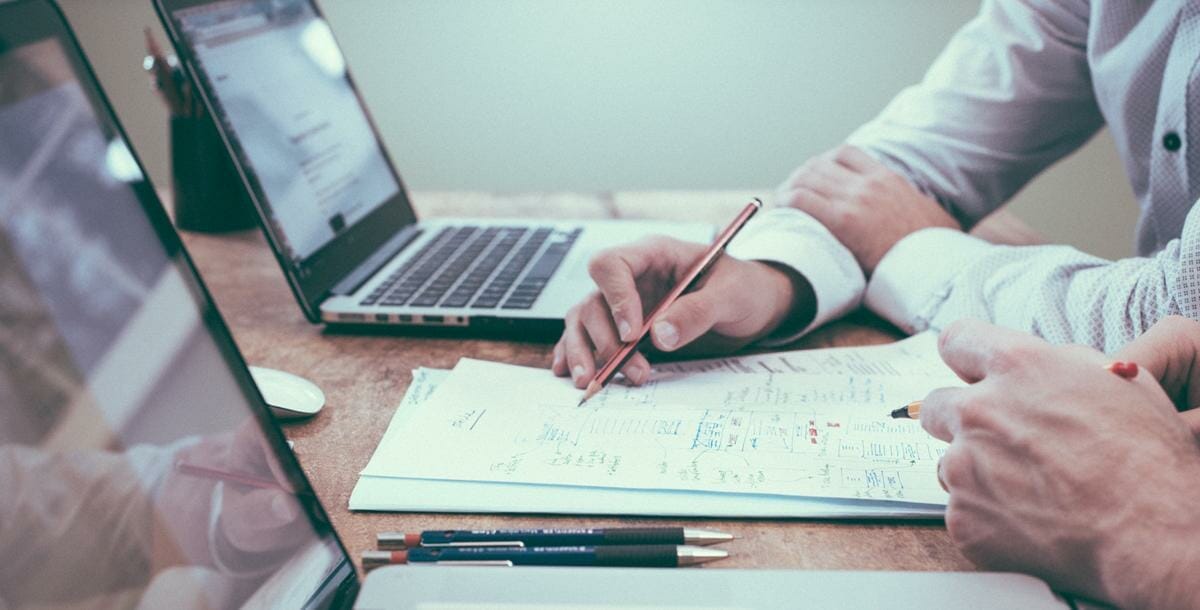 Photo of hand showing individual something on a piece of paper