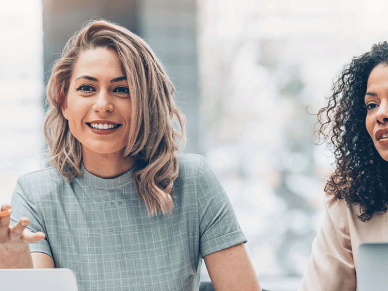 Female employees talking to someone behind camera