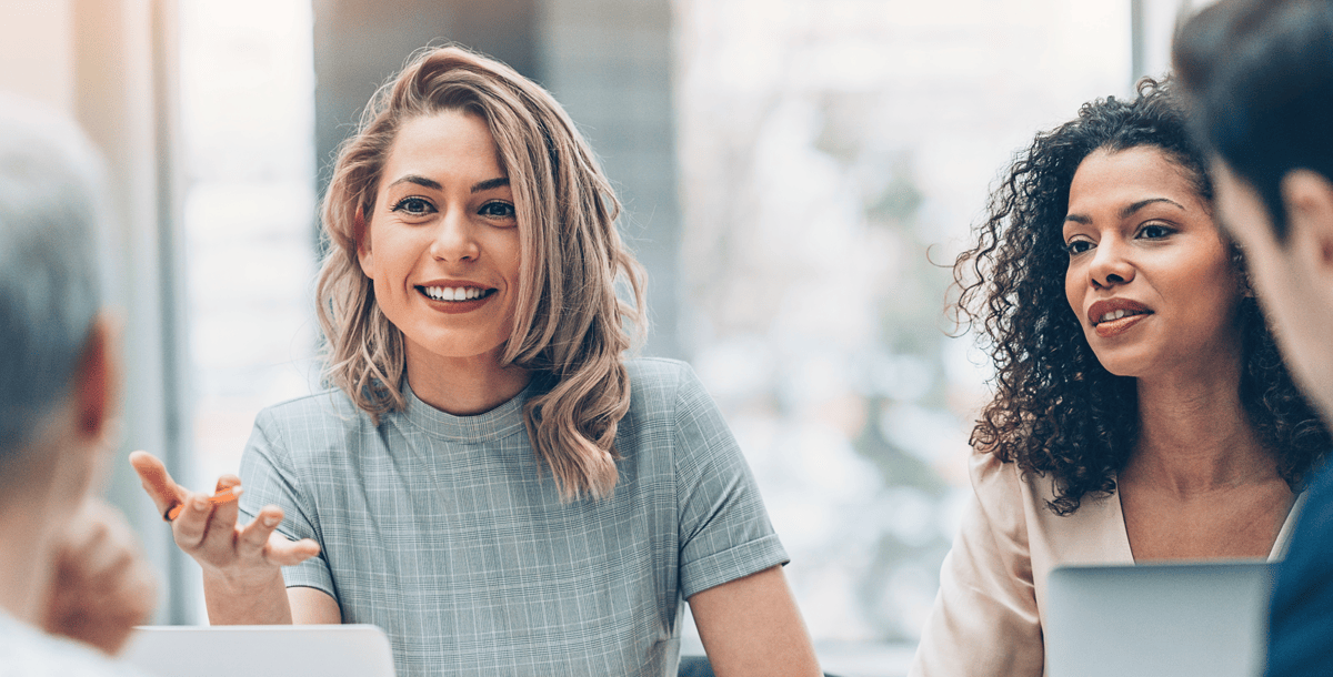 Female employees talking to someone behind camera