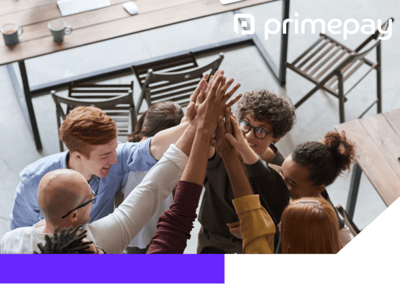 Photo of group of employees high fiving in a rectangle shaped frame